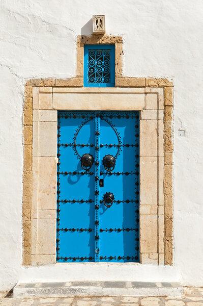 Beautiful ornamental blue door of so typical shape for Tunisia