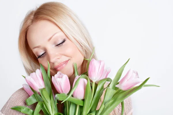 Beautiful blonde girl with tulips — Stock Photo, Image