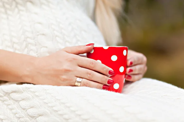 stock image Red cup in the hands