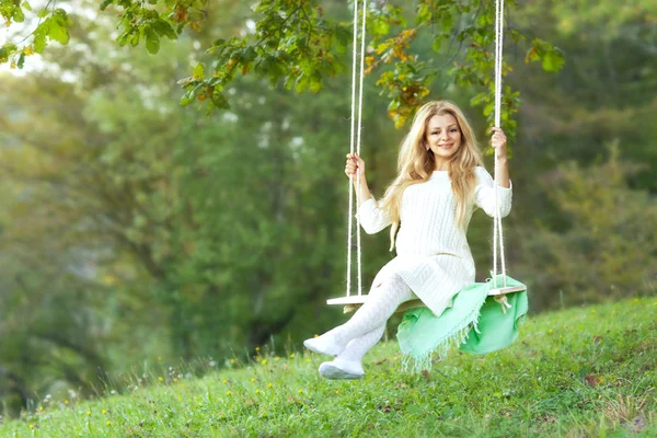 Cute pregnant girl and swing — Stock Photo, Image