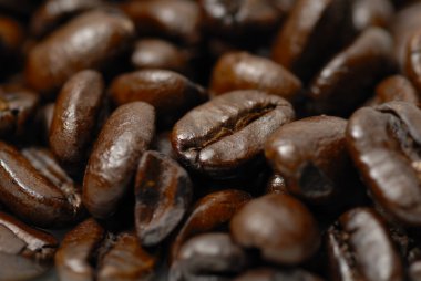 Fresh, dark arabica coffee beans. clipart