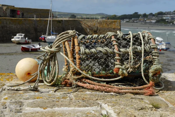 One empty lobster pot on harbour wall. — Stock Photo, Image