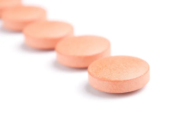 stock image Orange pills row close-up