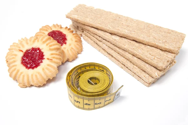 Difficult selection - cookies and crispbread with measuring type — Stock Photo, Image