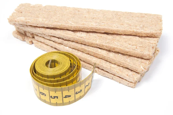 Stack of low caloric crispbread with measuring type — Stock Photo, Image