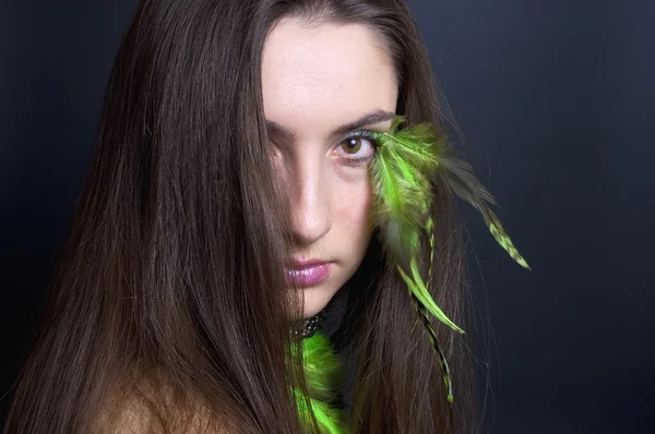 Young woman with feathers — Stock Photo, Image