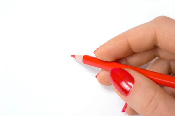 Rød blyant i hånden – stockfoto