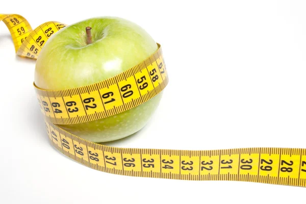 Green Apple with measuring tape, isolated on white Royalty Free Stock Images
