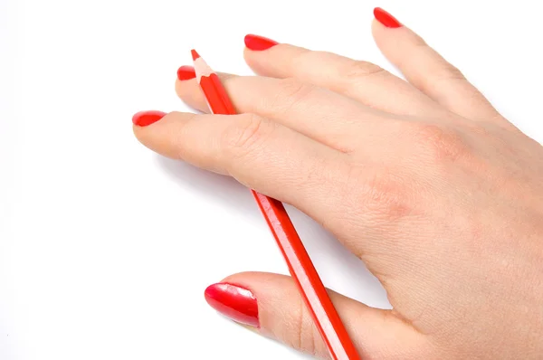 Red pencil in hand Royalty Free Stock Photos