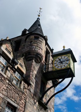 Old city clock on stone tower clipart