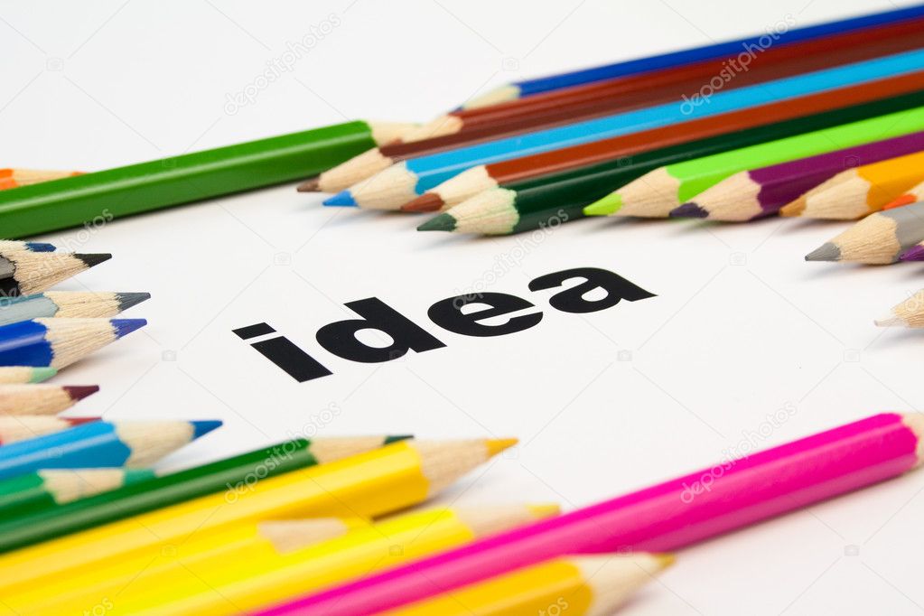 Many colored pencils arranged around the word idea
