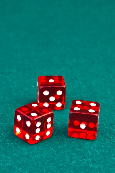 Three reds dice on green — Stock Photo, Image