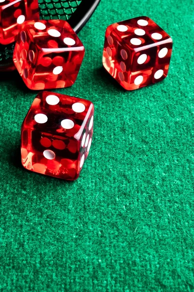 Red dice in corner in of a green table — Stock Photo, Image
