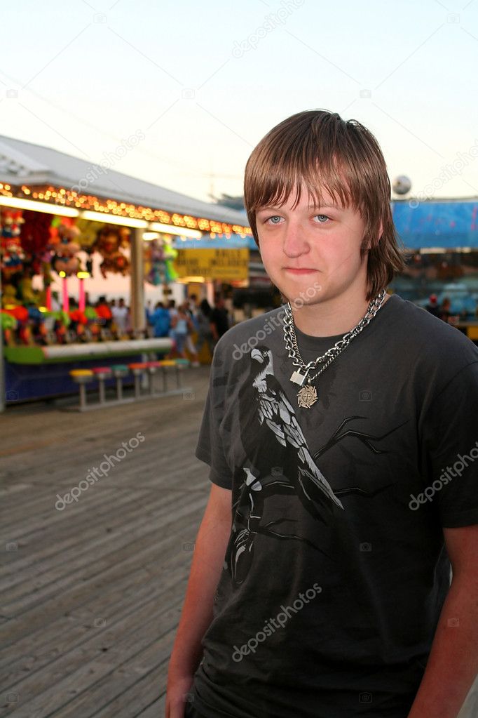Sad Teen On Festive Boardwalk