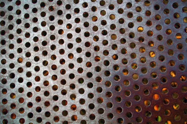 Metalloberfläche mit Löchern Stockbild