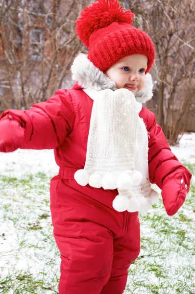 A baby girl in red snowsuit — Stock Photo, Image