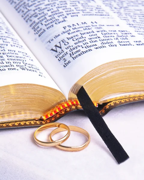 Закрытая Библия и обручальные кольца — стоковое фото