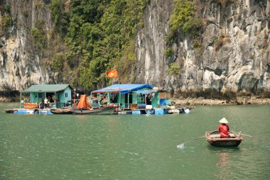 Vietnamese sea gypsy village in halong bay clipart