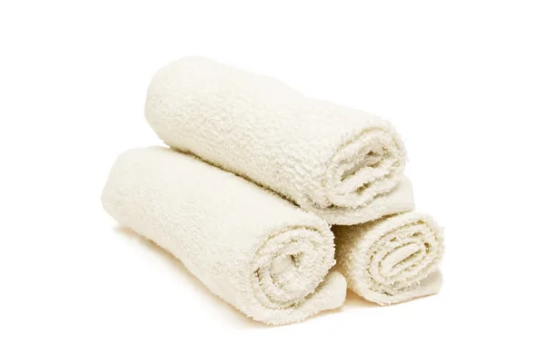Rolled fluffy towels on shelf in bathroom Stock Photo by FabrikaPhoto