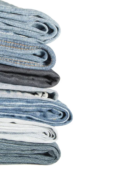 A pile of jeans on a white background — Stock Photo, Image