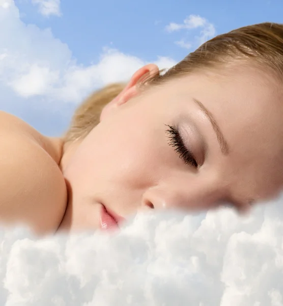 Portrait of a young girl sleeping with clouds — Stock Photo, Image