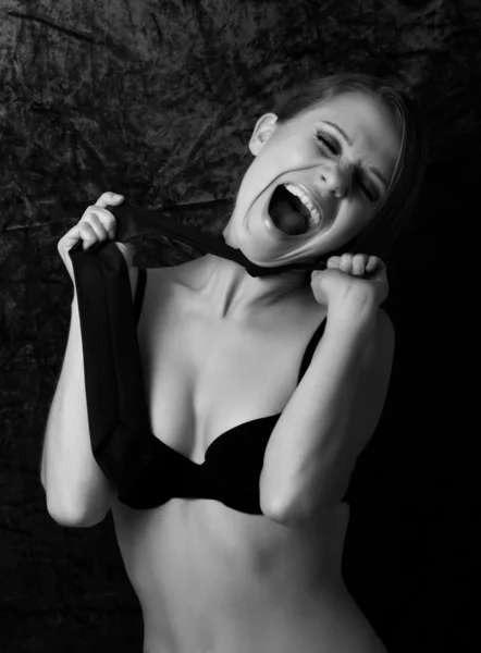 Wild girl in a bra shouting in the dark — Stock Photo, Image