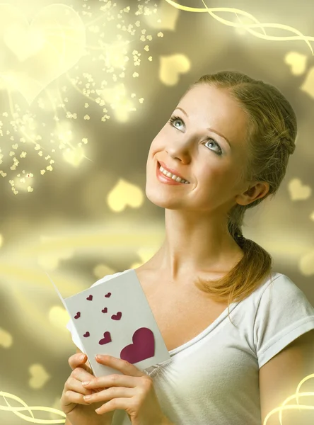 Attractive happy girl , reading valentine card — Stock Photo, Image