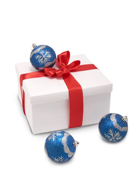 White box with red ribbon and Christmas decorations — Stock Photo, Image