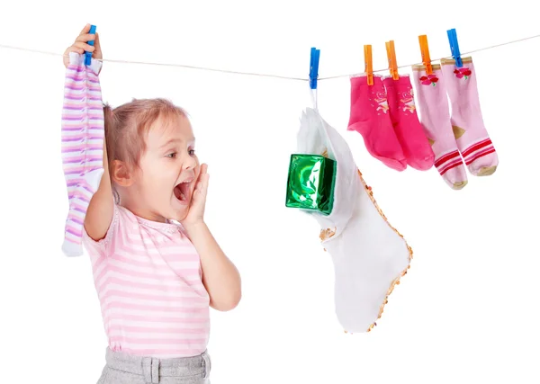 Beautiful girl hangs socks — Stock Photo, Image
