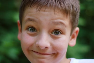 Fun boy face with eyebrows elevated, close-up clipart