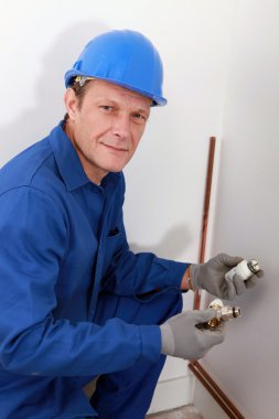 Plumber fixing heating system clipart