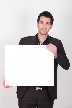 Young dark-haired man holding canvas clipart