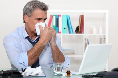 Office worker suffering from a cold clipart