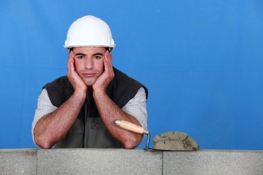A frustrated bricklayer clipart