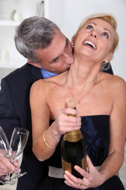 Man kissing his wife's neck clipart