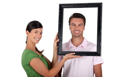 Couple holding empty picture frame clipart