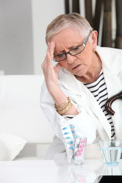 Older woman with a headache — Stock Photo, Image