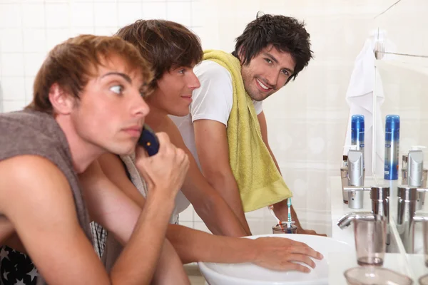 Three young men in bathroom — Stock Photo, Image