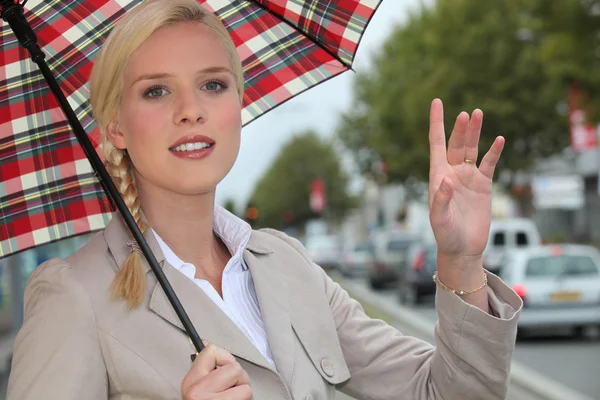 Stock image Woman hailing a taxi