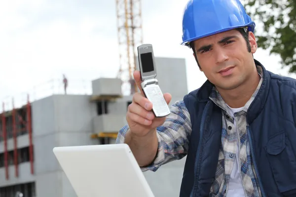 Foreman on construction site holding telephone — Stock Photo, Image