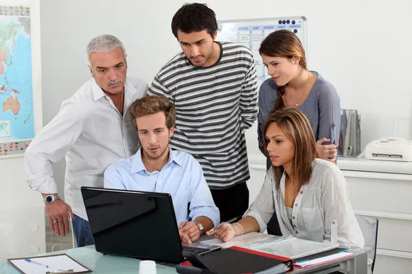 Trainees looking at a laptop Stock Picture