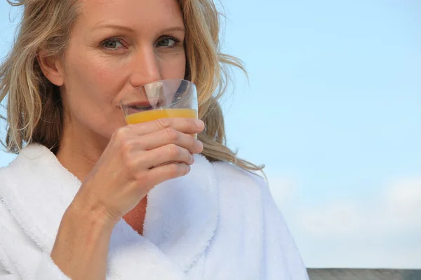 Woman drinking orange juice Royalty Free Stock Photos