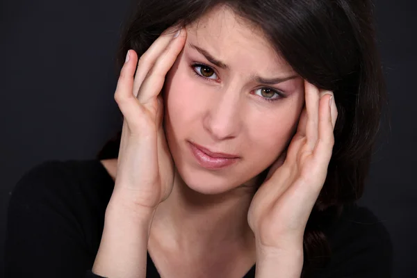 Woman having a headache Stock Image