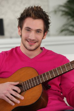 Young man playing the guitar clipart