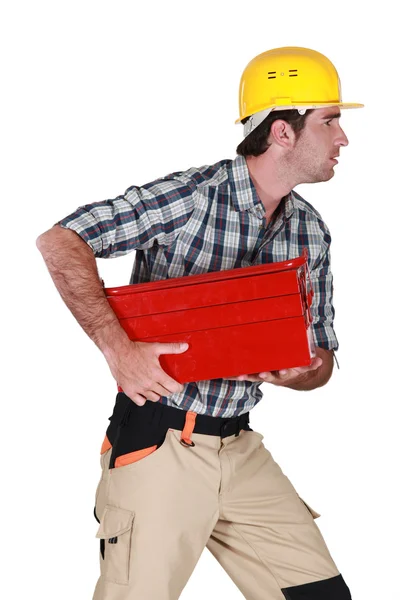 Craftsman running and holding a toolbox — Stock Photo, Image