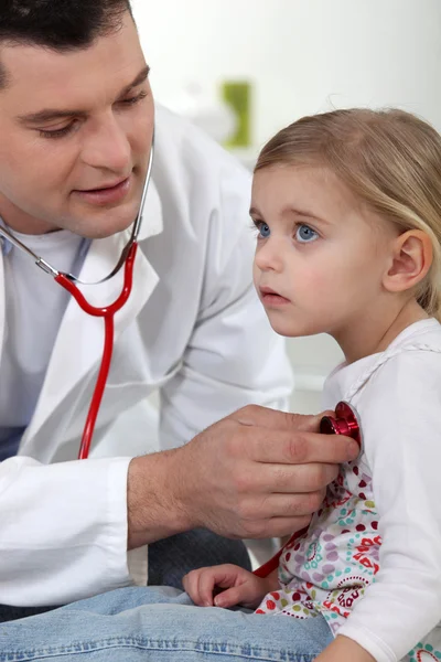 stock image A doctor with a little girl.