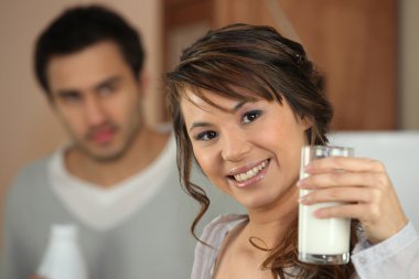 Young woman with a glass of milk clipart