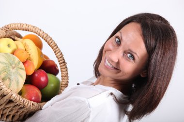 Woman holding a fruits basket clipart