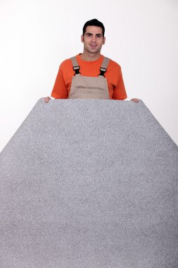 Man with a roll of carpet clipart