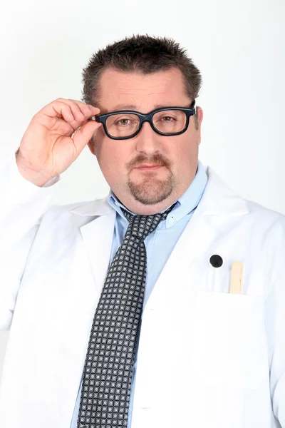 Doctor putting on his glasses — Stock Photo, Image
